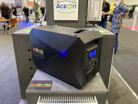 A picture showing the AceOn portable energy storage unit, which is black with the AceOn PES logo on the site in orange and green.